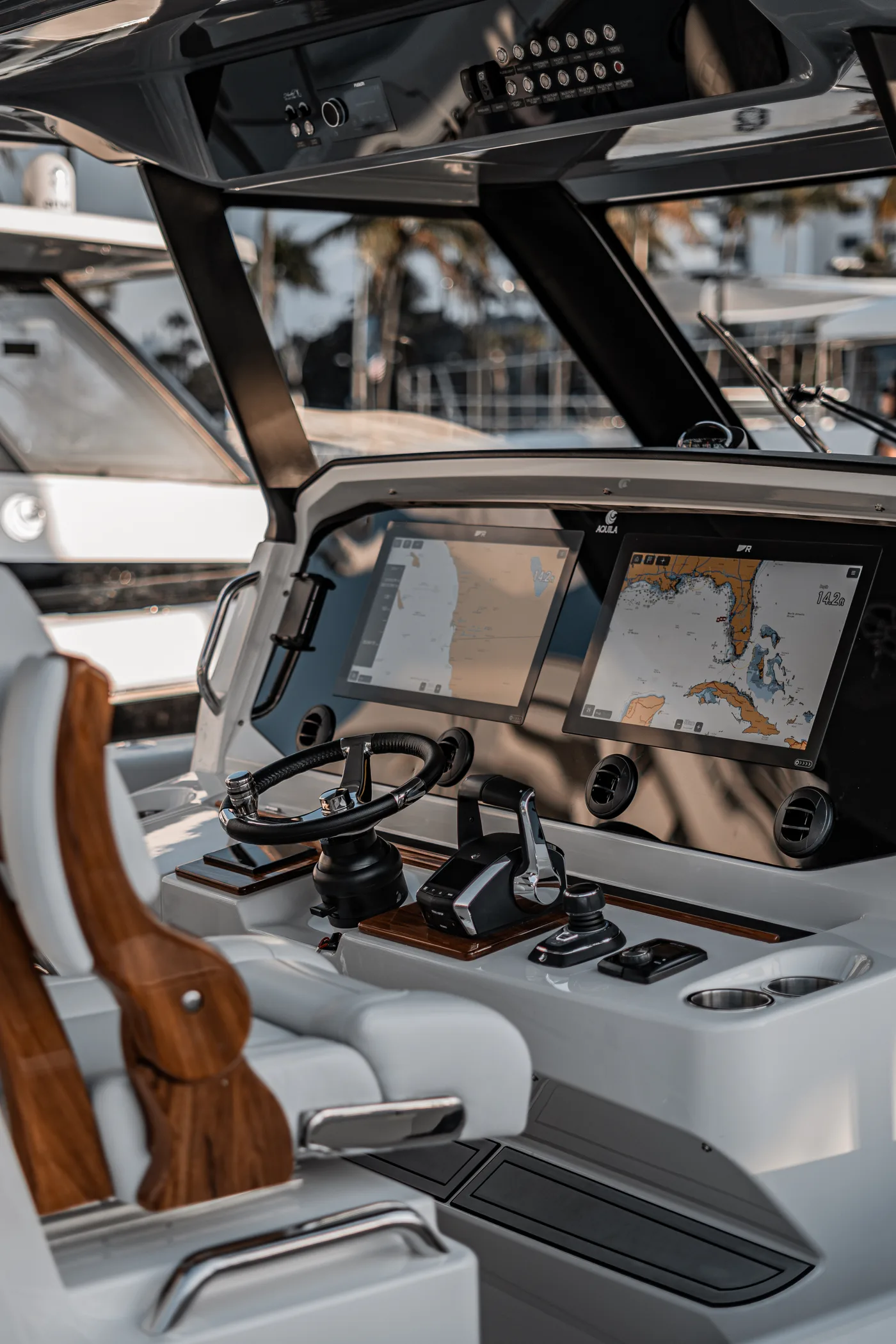 Aquila — teak-trimmed helm and electronics