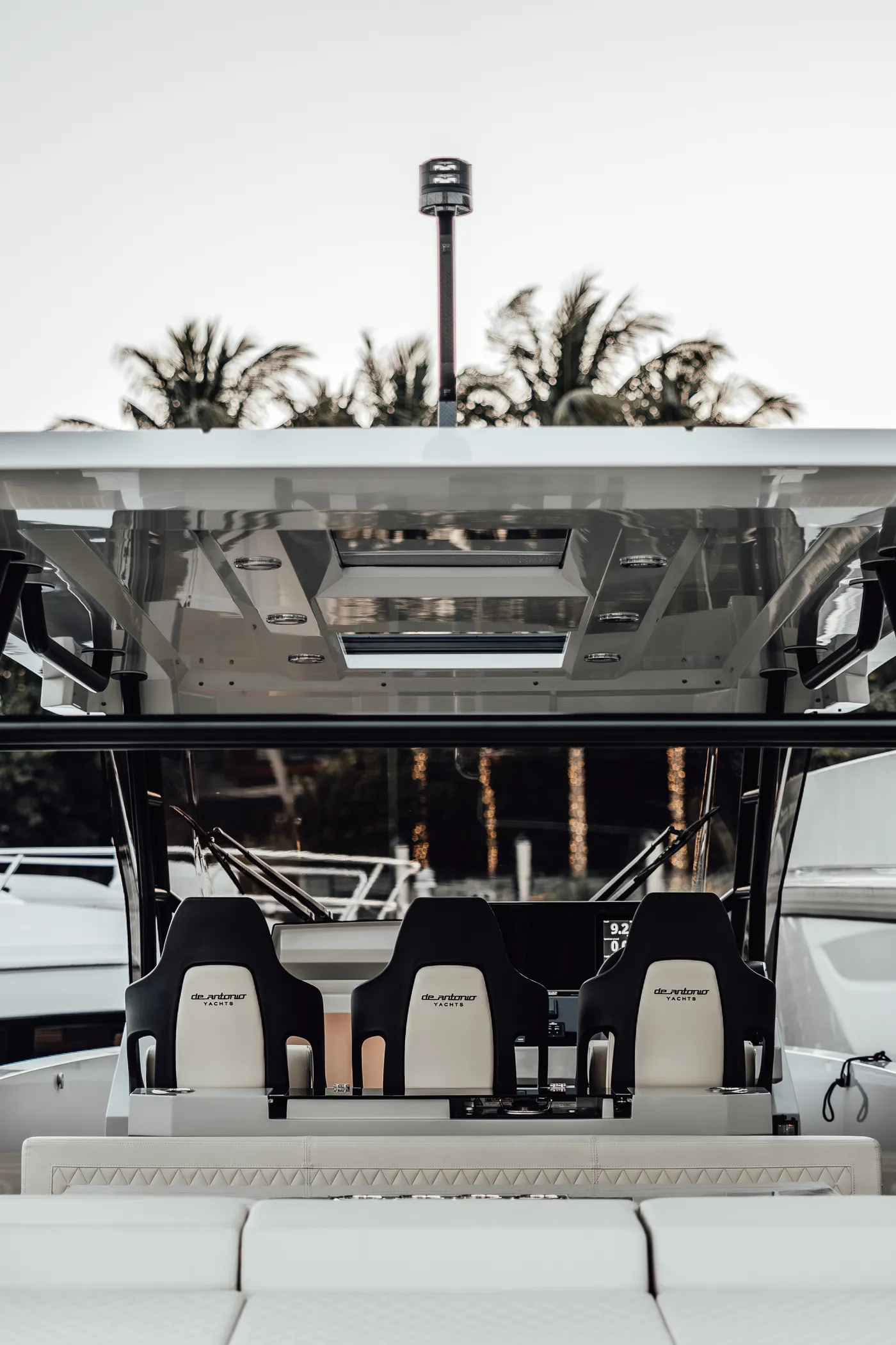 De Antonio — bow seating with palms behind