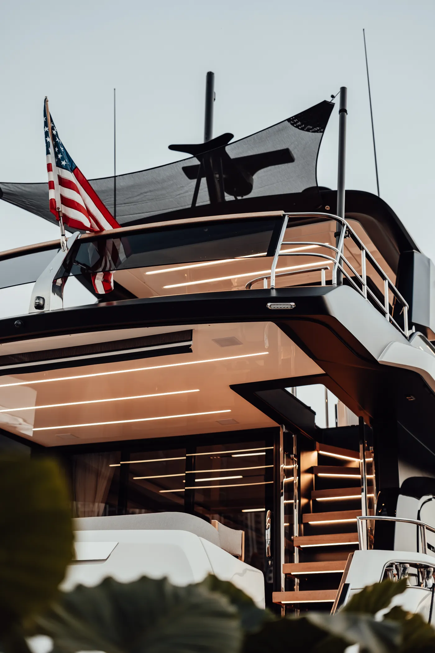 Yachts and flags along the marina at dusk