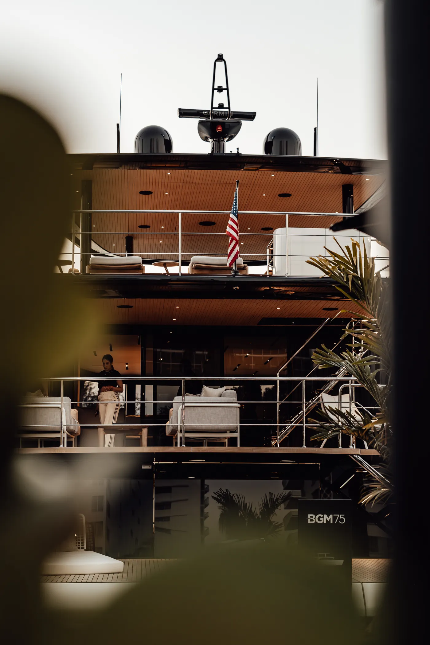 A multi-deck superyacht at dusk
