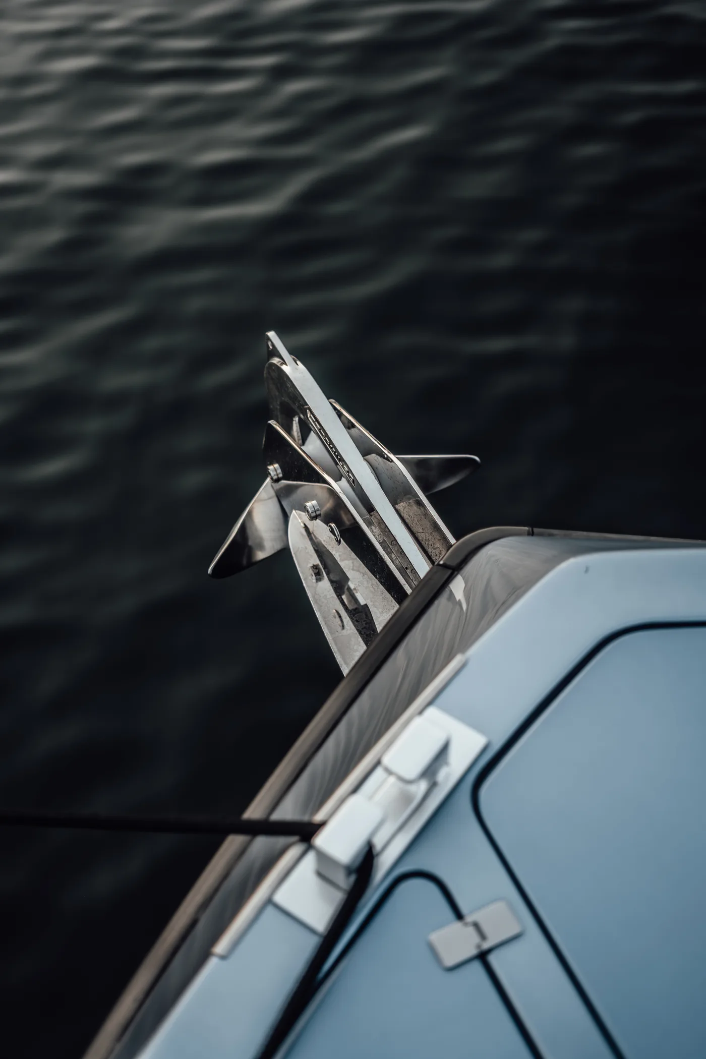 A bow and anchor against the water at dusk