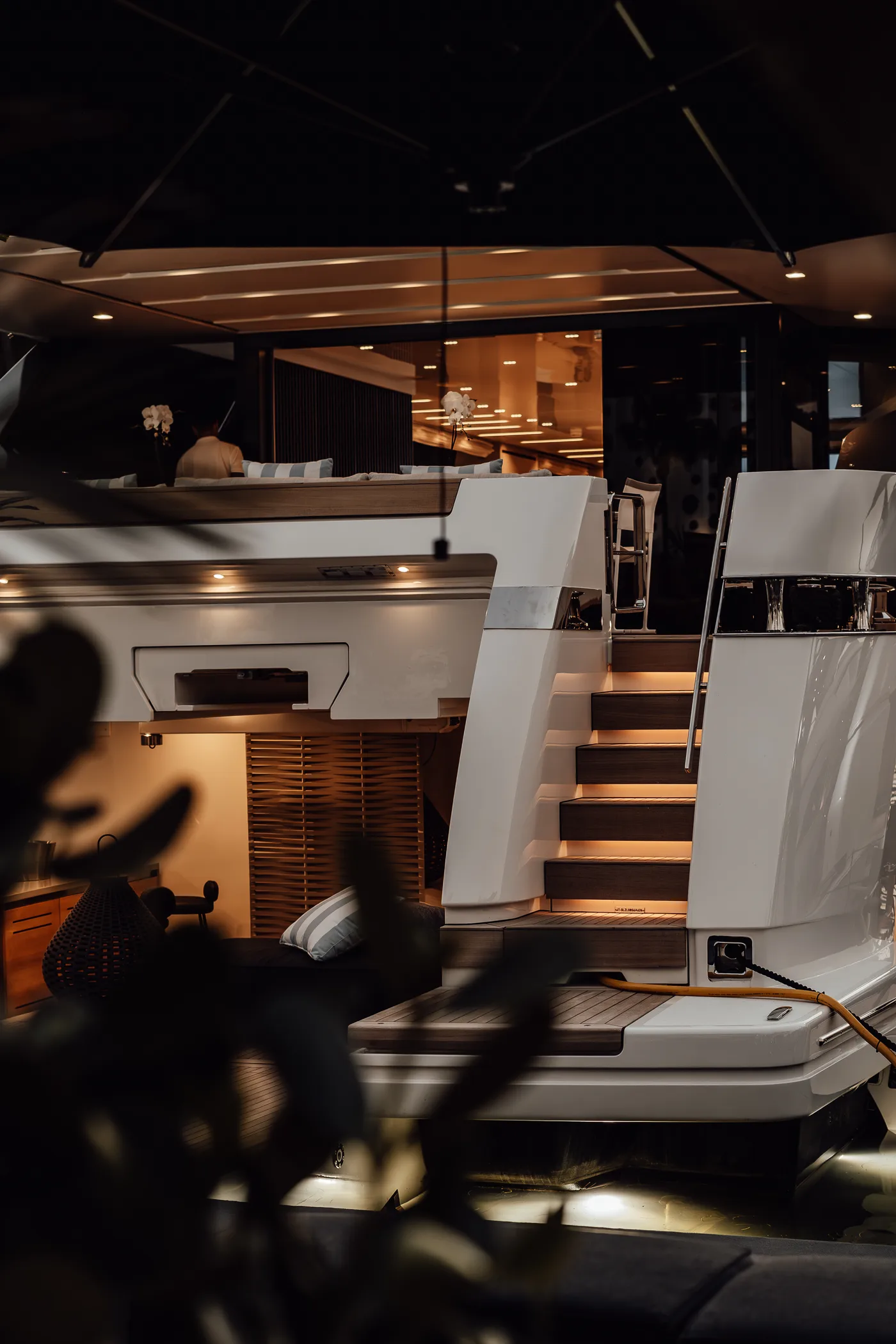 A warm-lit yacht interior stairway