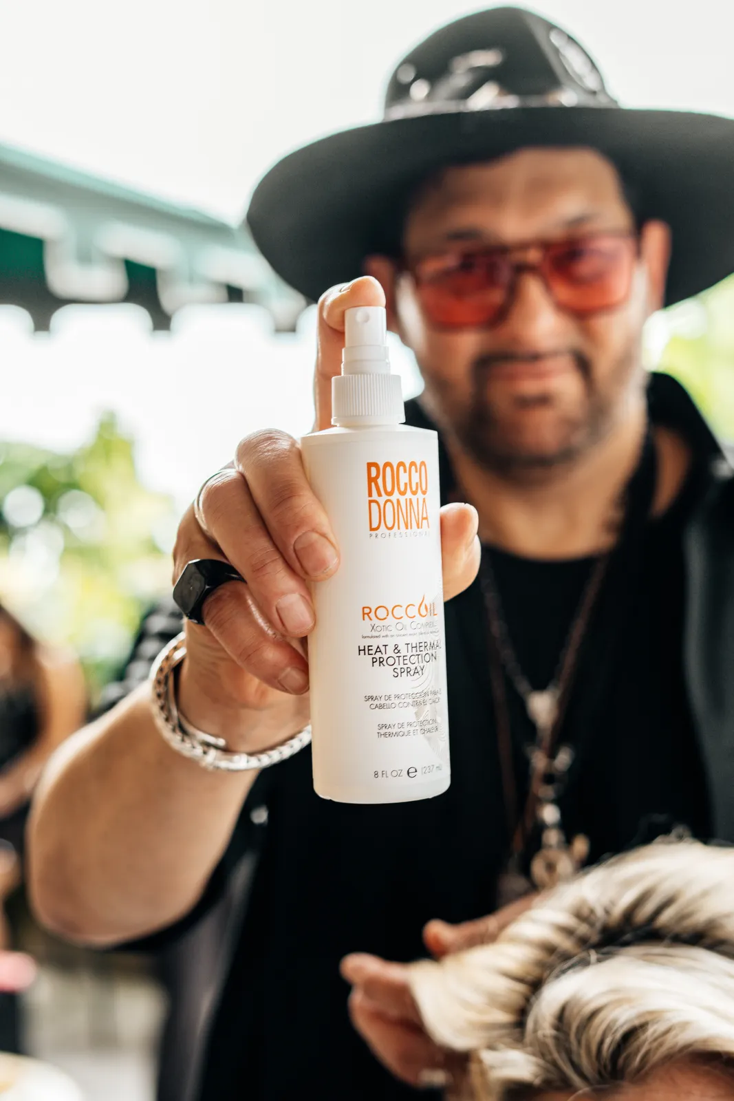 A stylist with the hair products used backstage