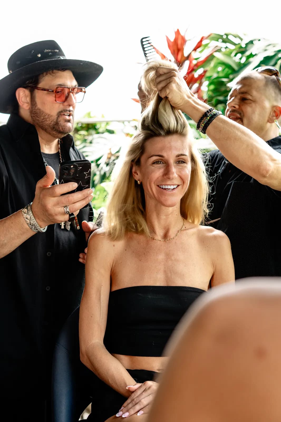 The team styling a model as the show is prepared