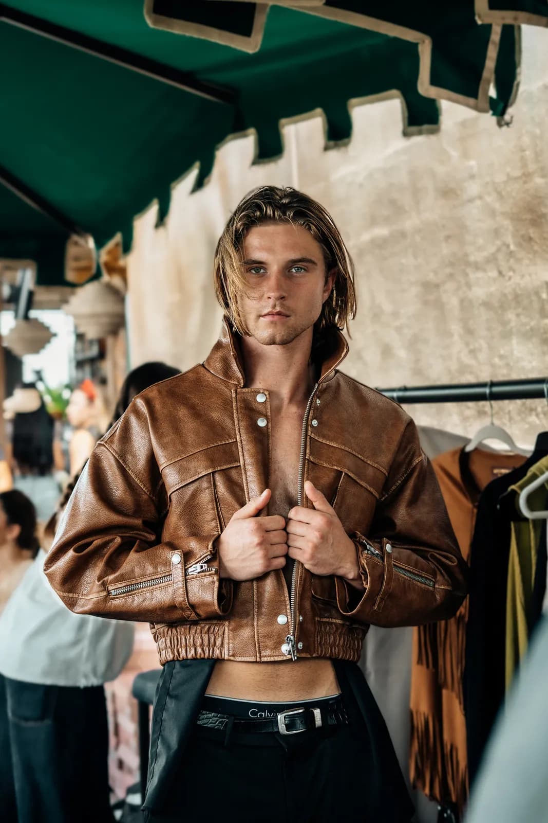 A male model in a leather look before the show