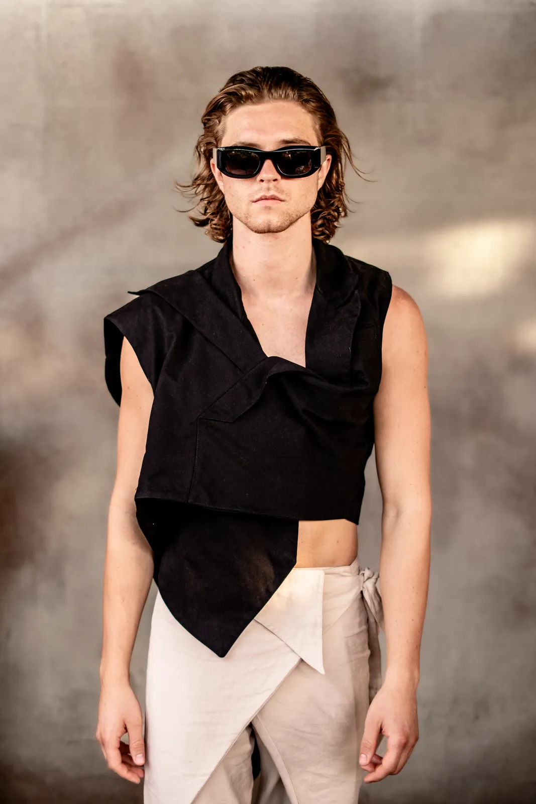 A male model in an asymmetric black look