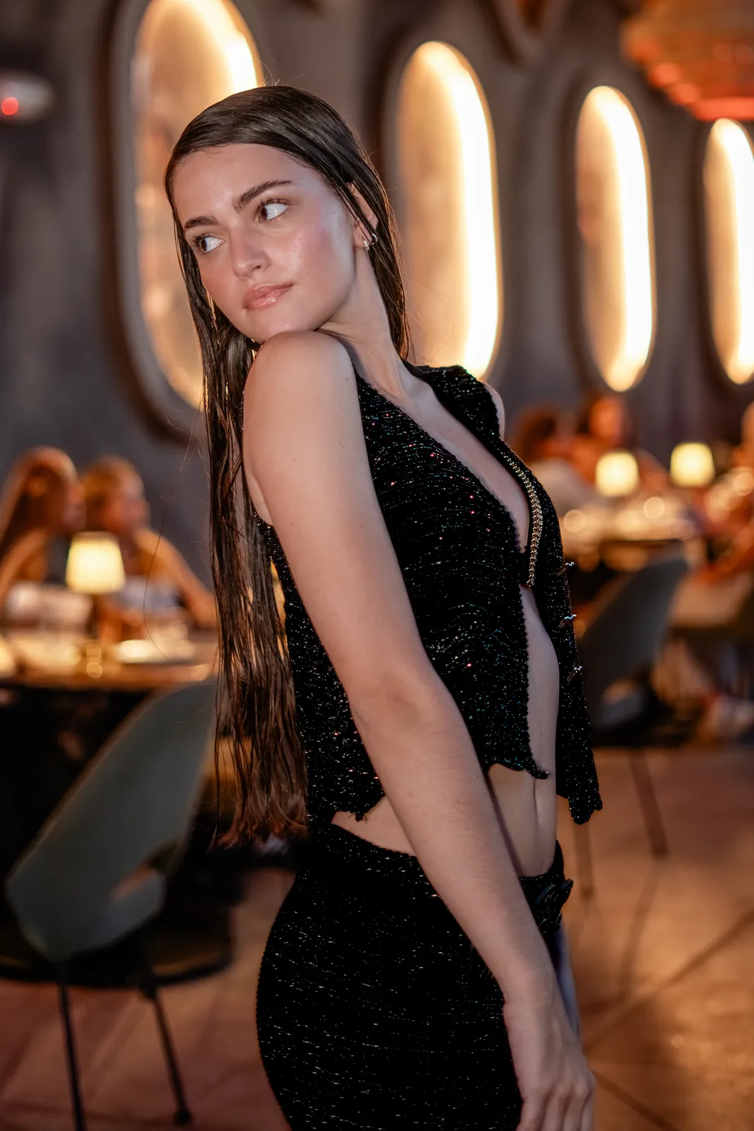 A model in a black gown looking back