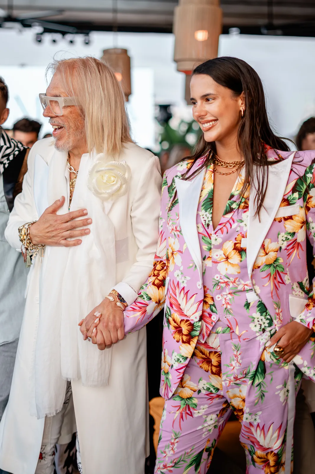 The designer closing the show with a model in a floral suit