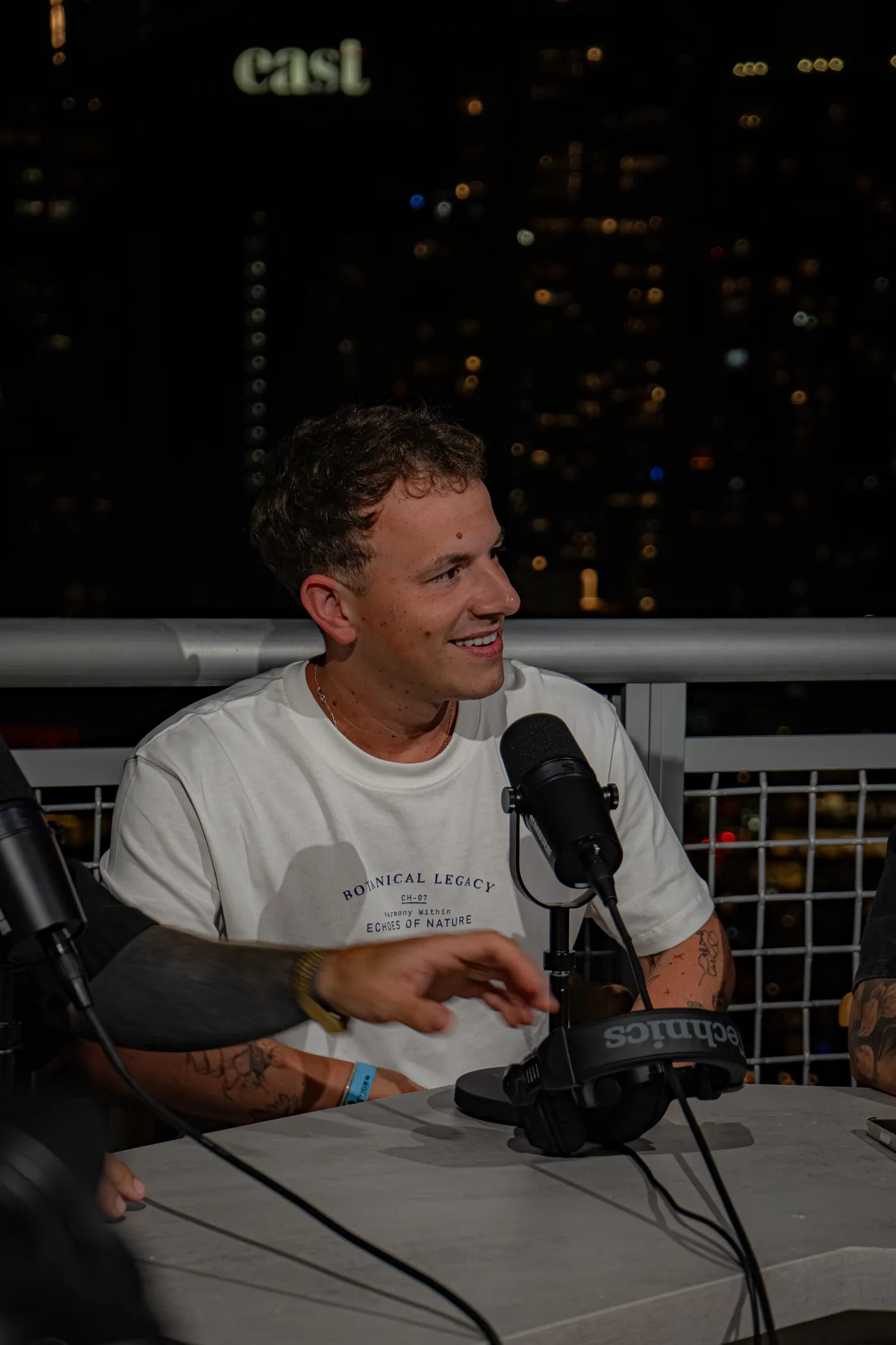 At the mic in a white tee