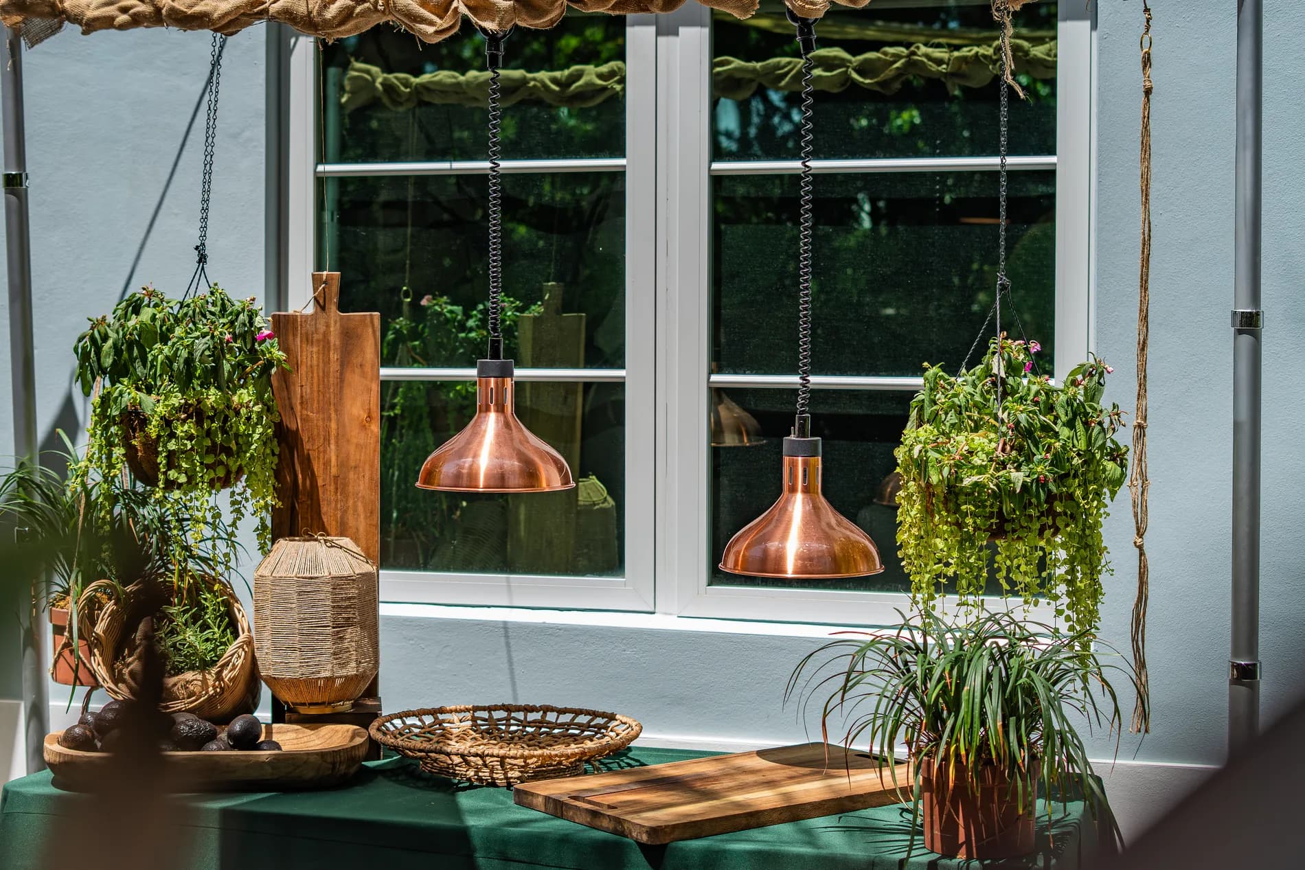 Copper pendants and styled greenery as installed