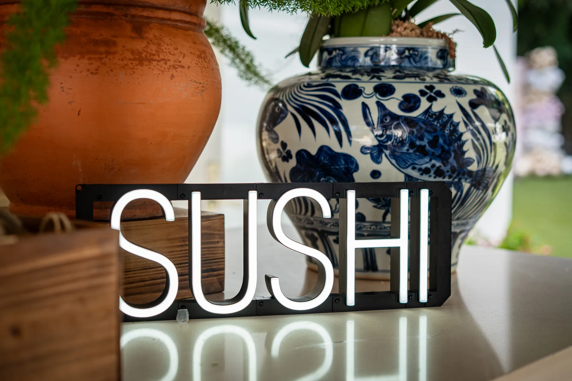 The illuminated sushi sign in position