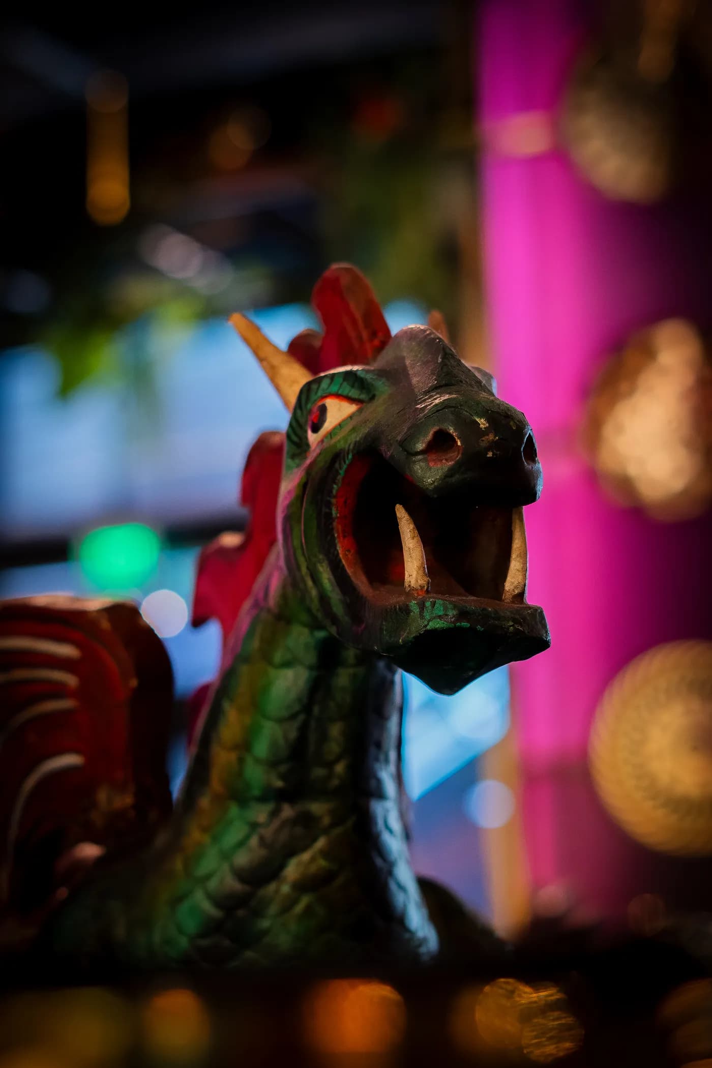 A carved dragon against the magenta interior
