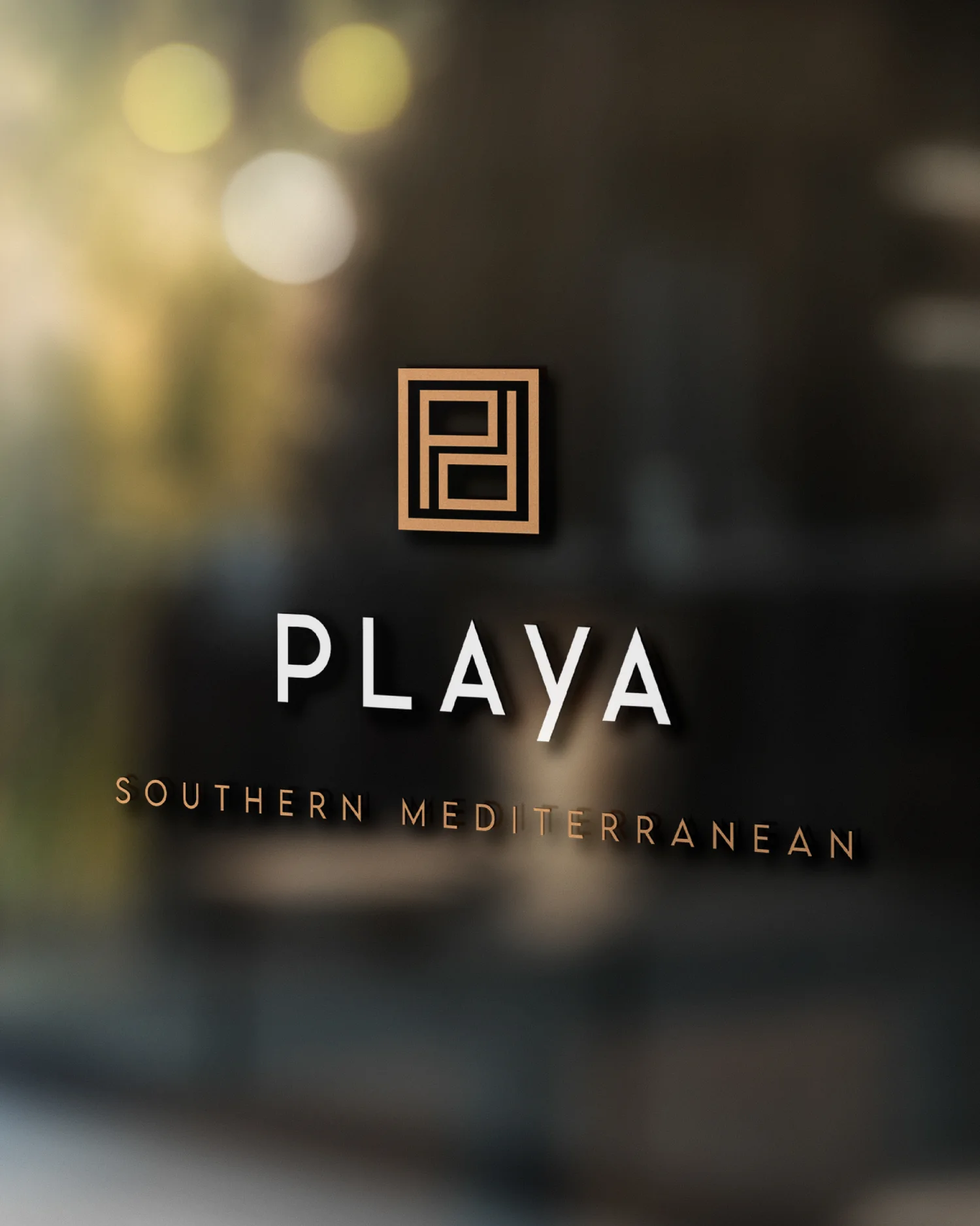 The Playa mark etched on a storefront window