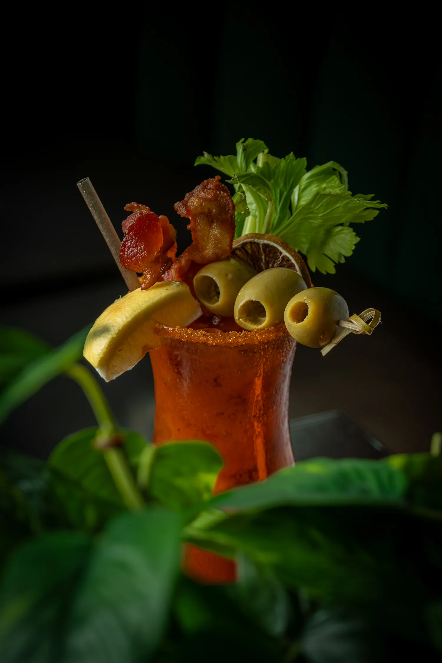 A loaded bloody mary with bacon, olives and celery