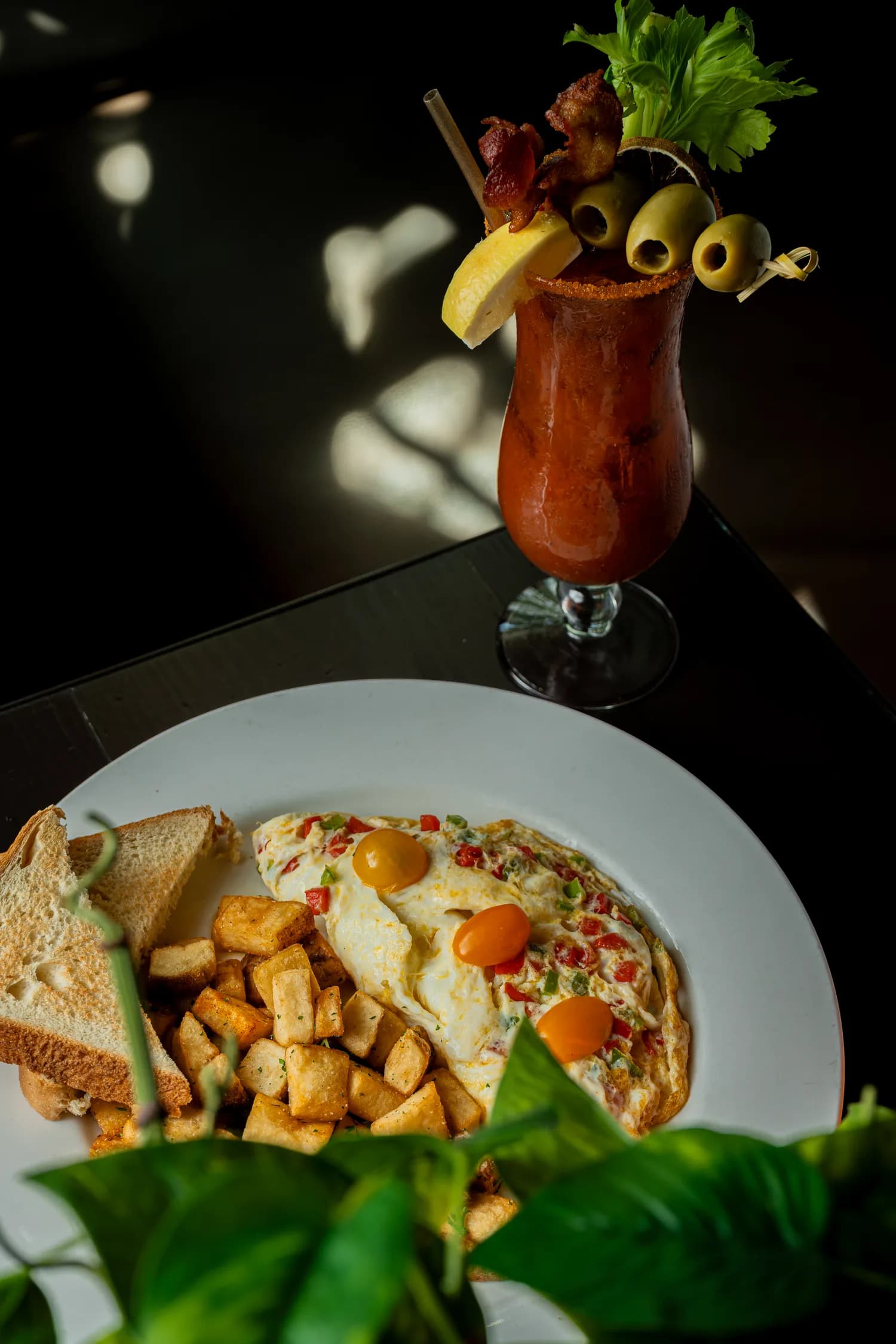 A loaded bloody mary with an eggs benedict plate