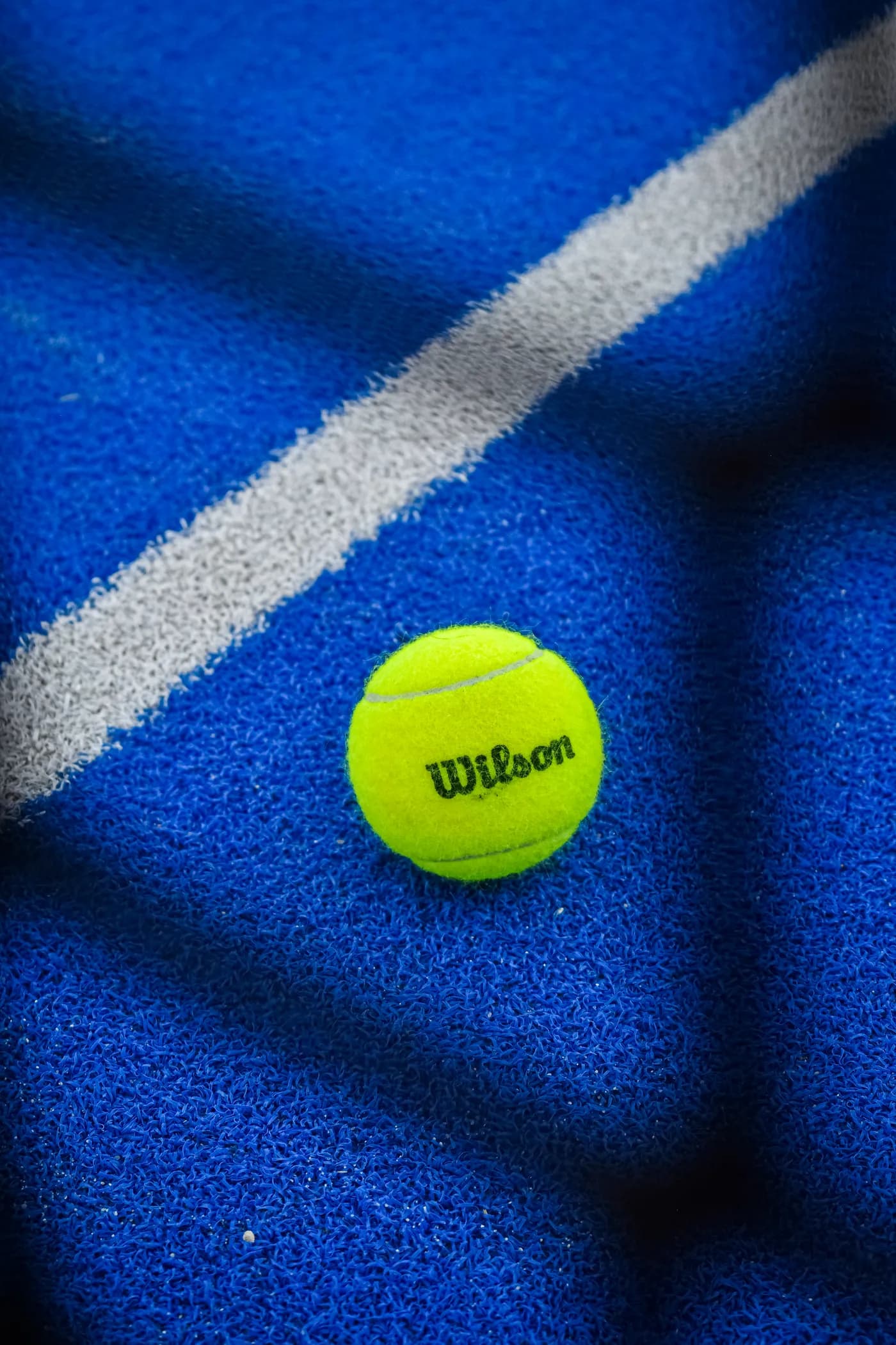 A ball resting on the blue court line