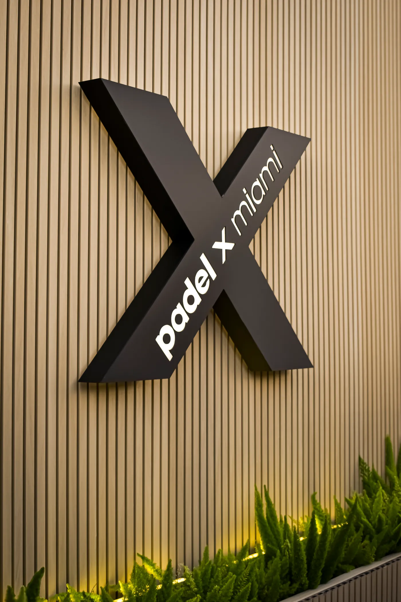 The Padel X Miami wordmark on the clubhouse wall