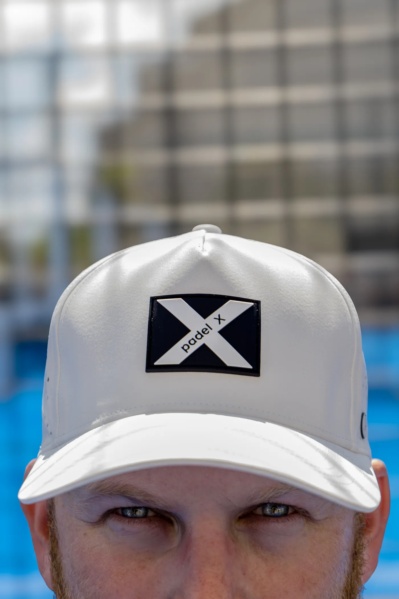 A Padel X cap worn straight on