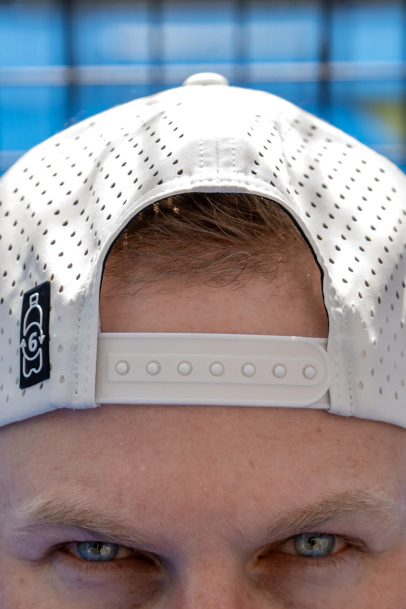 The cap's back strap and badge