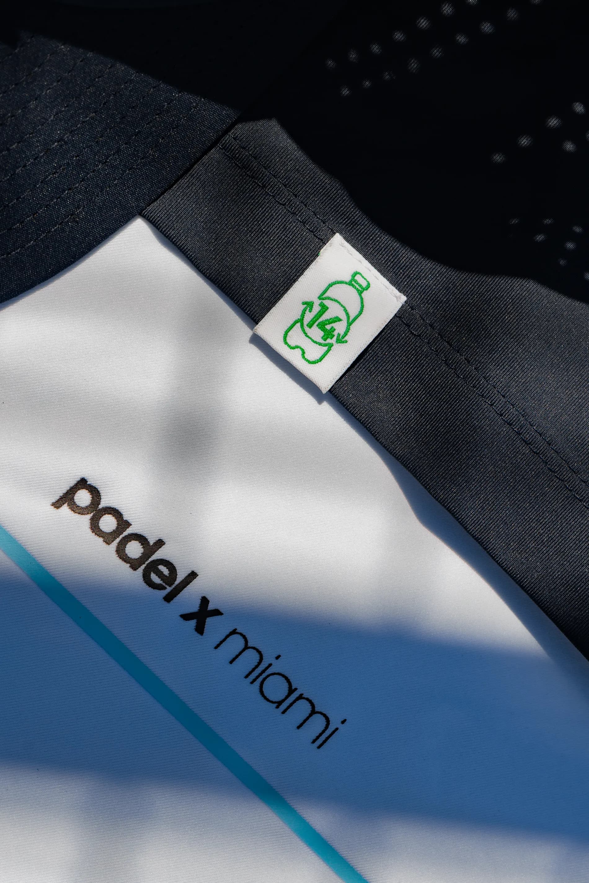 Padel X Miami apparel laid out on the court